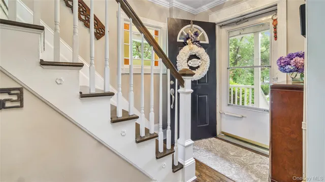 a view of entryway and hall with wooden floor