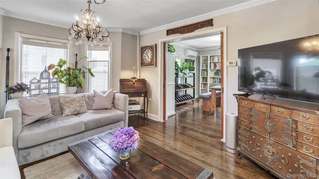 a living room with furniture and a chandelier