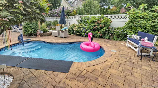 a view of a house with backyard and sitting area