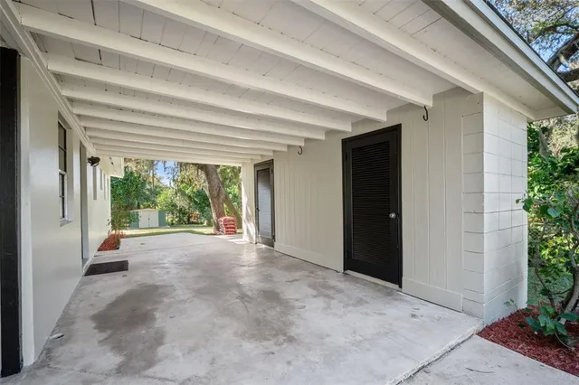 a view of a house with porch and garden