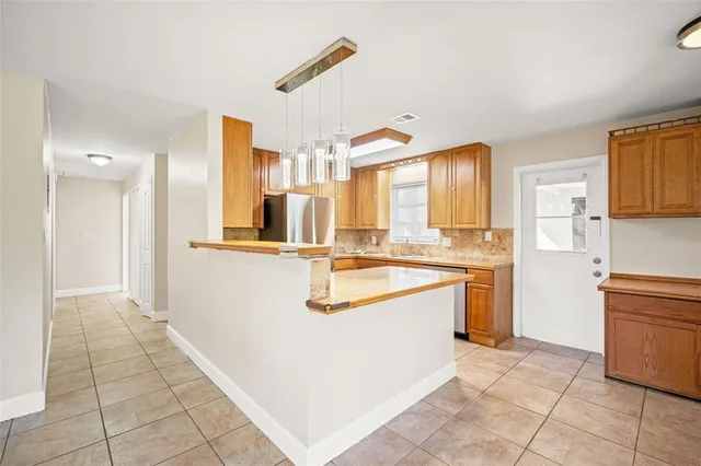 a large kitchen with a sink and cabinets