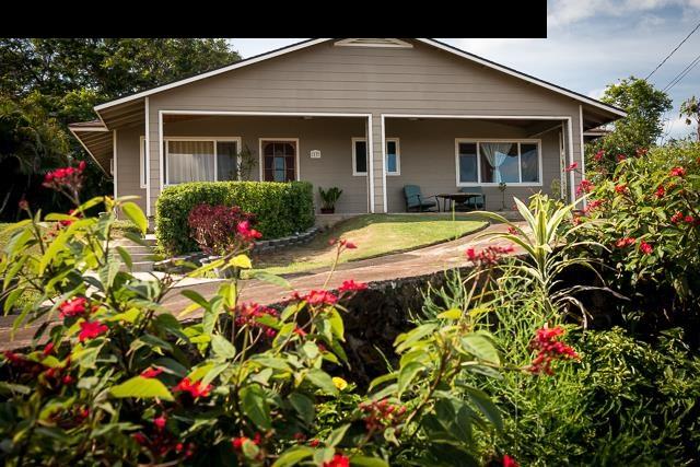 a view of a house with a yard and garden