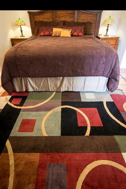 17 Holopuni Road Kula, HI 96790 - Photo 19 of 30 a bedroom with a bed and a painting on the wall