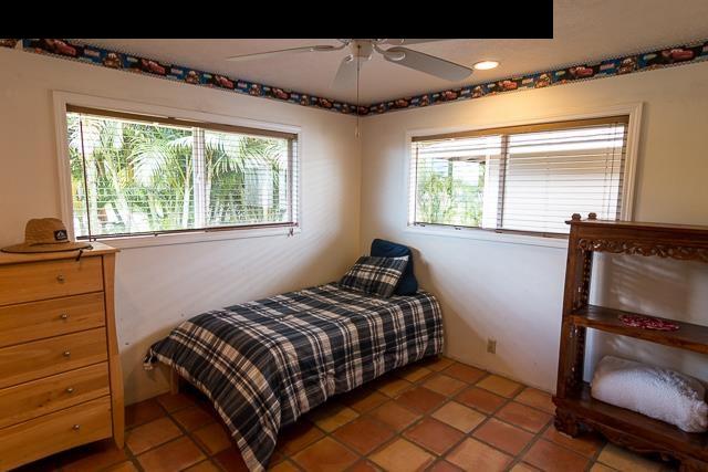 17 Holopuni Road Kula, HI 96790 - Photo 20 of 30 a bedroom with a bed and a window