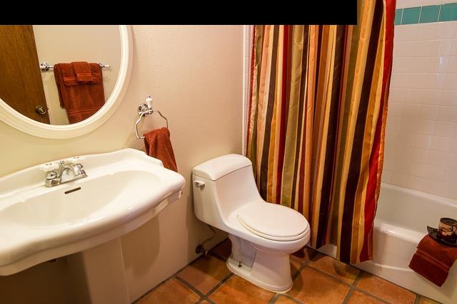 17 Holopuni Road Kula, HI 96790 - Photo 21 of 30 a white toilet sitting next to a bathroom sink