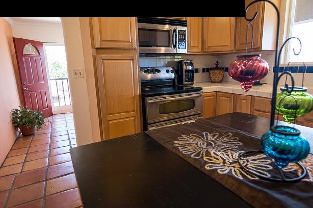 17 Holopuni Road Kula, HI 96790 - Photo 22 of 30 a kitchen with stainless steel appliances a stove a sink and a microwave