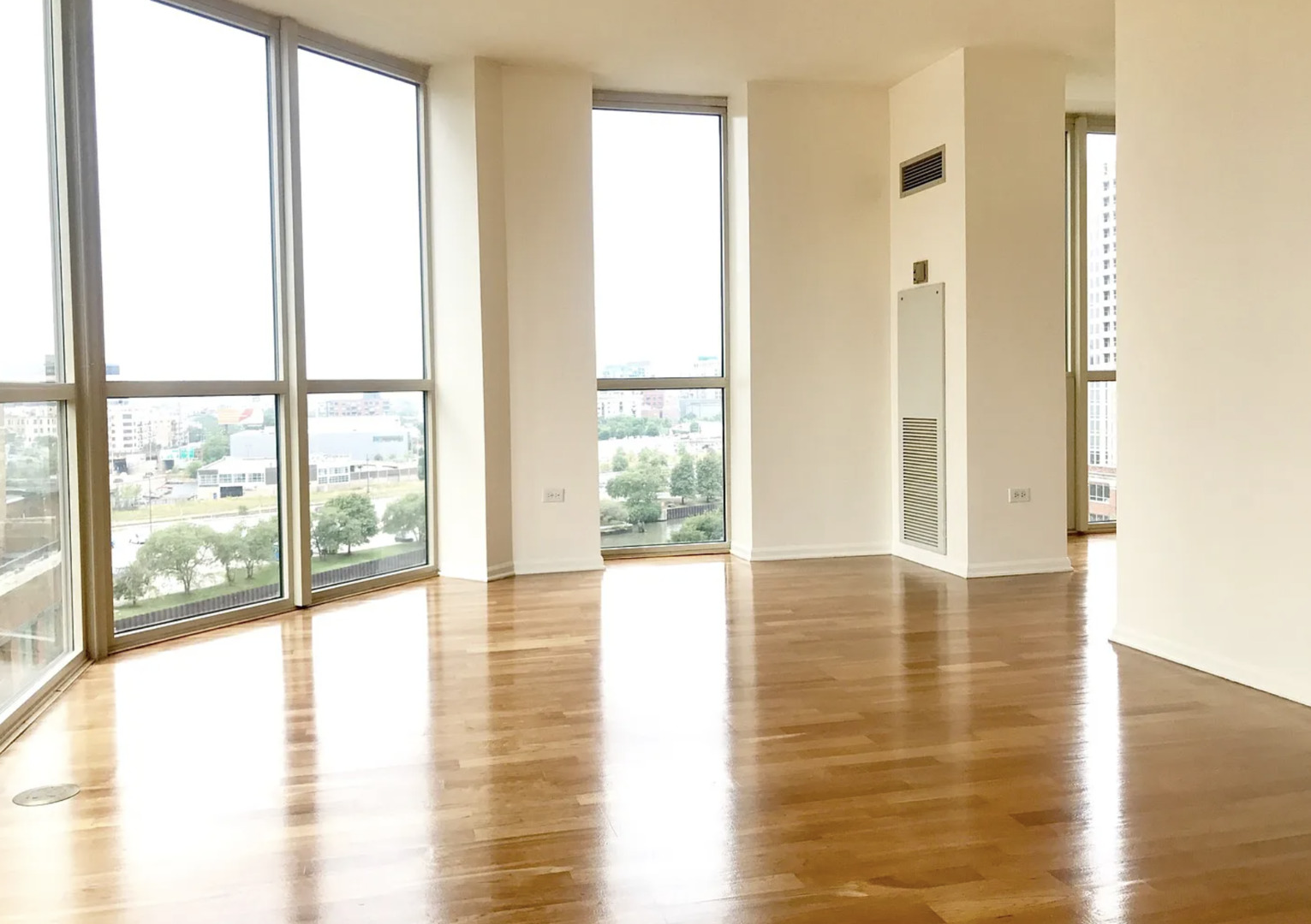 645 North Kingsbury Street, Unit 1002 Chicago, IL 60654 - Photo 3 of 11 a view of an empty room with wooden floor and a window