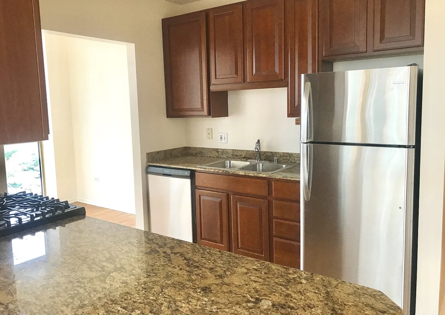 645 North Kingsbury Street, Unit 1002 Chicago, IL 60654 - Photo 7 of 11 a kitchen with stainless steel appliances granite countertop a refrigerator a stove a sink and a cabinets