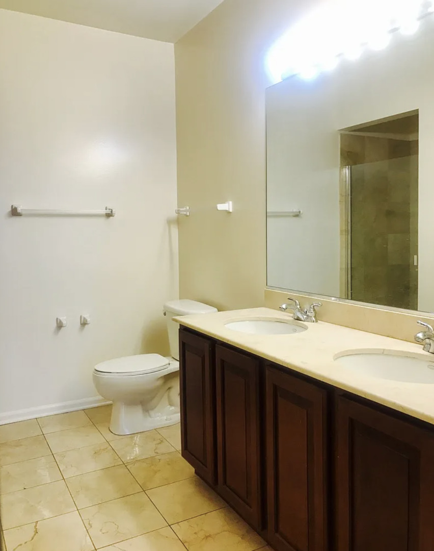 645 North Kingsbury Street, Unit 1002 Chicago, IL 60654 - Photo 8 of 11 a bathroom with a sink a toilet and shower