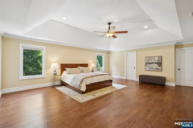 a spacious bedroom with a bed a couch and a window