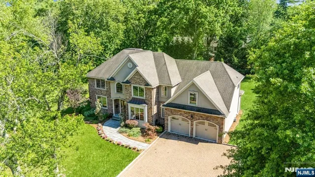 an aerial view of a house with swimming pool and garden