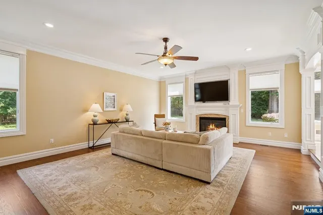 a living room with furniture a fireplace and a flat screen tv
