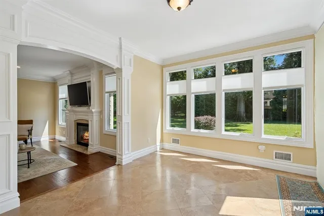 a view of a livingroom with a fireplace and windows