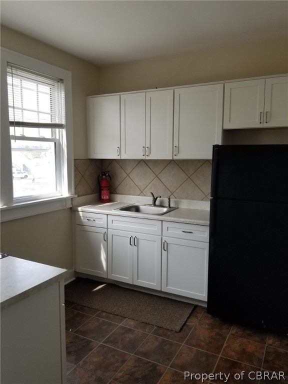 75 South Main Street, Unit 1 Kilmarnock, VA 22482 - Photo 6 of 9 a kitchen with a sink window and cabinets