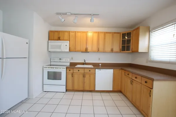 a kitchen with a stove a sink and a refrigerator