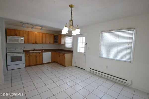 a kitchen with stainless steel appliances granite countertop a sink cabinets and a counter top space