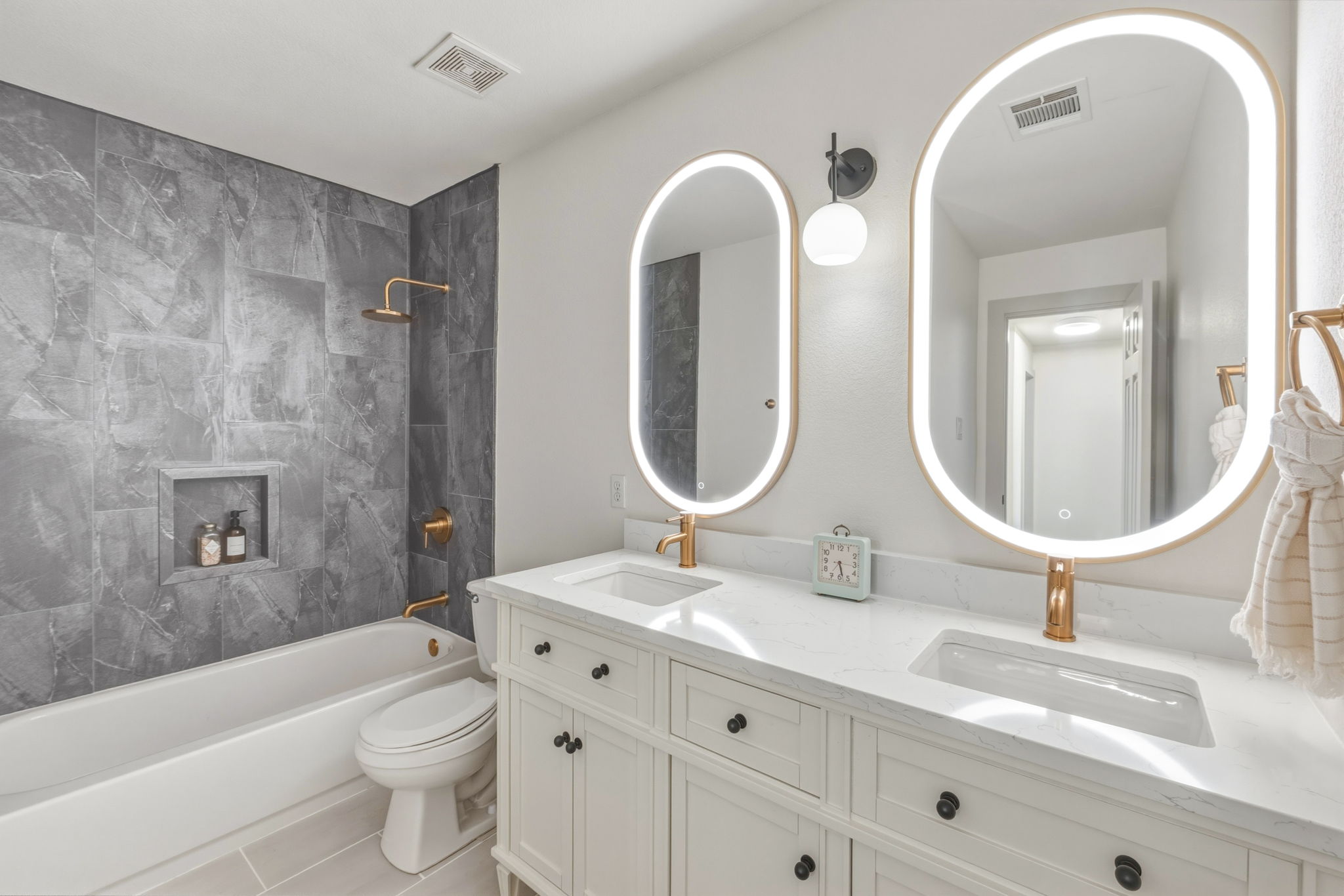 211 Banner Avenue Leander, TX 78641 - Photo 20 of 27 a bathroom with a double vanity sink toilet mirror and bathtub