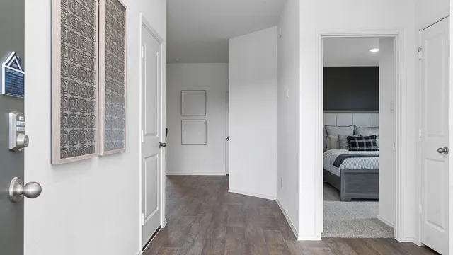 a view of a hallway with wooden floor and closet
