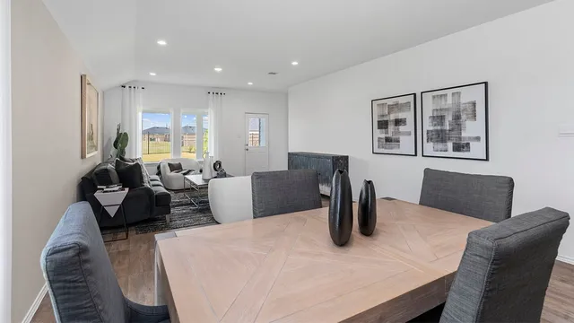 a kitchen with a dining table and chairs