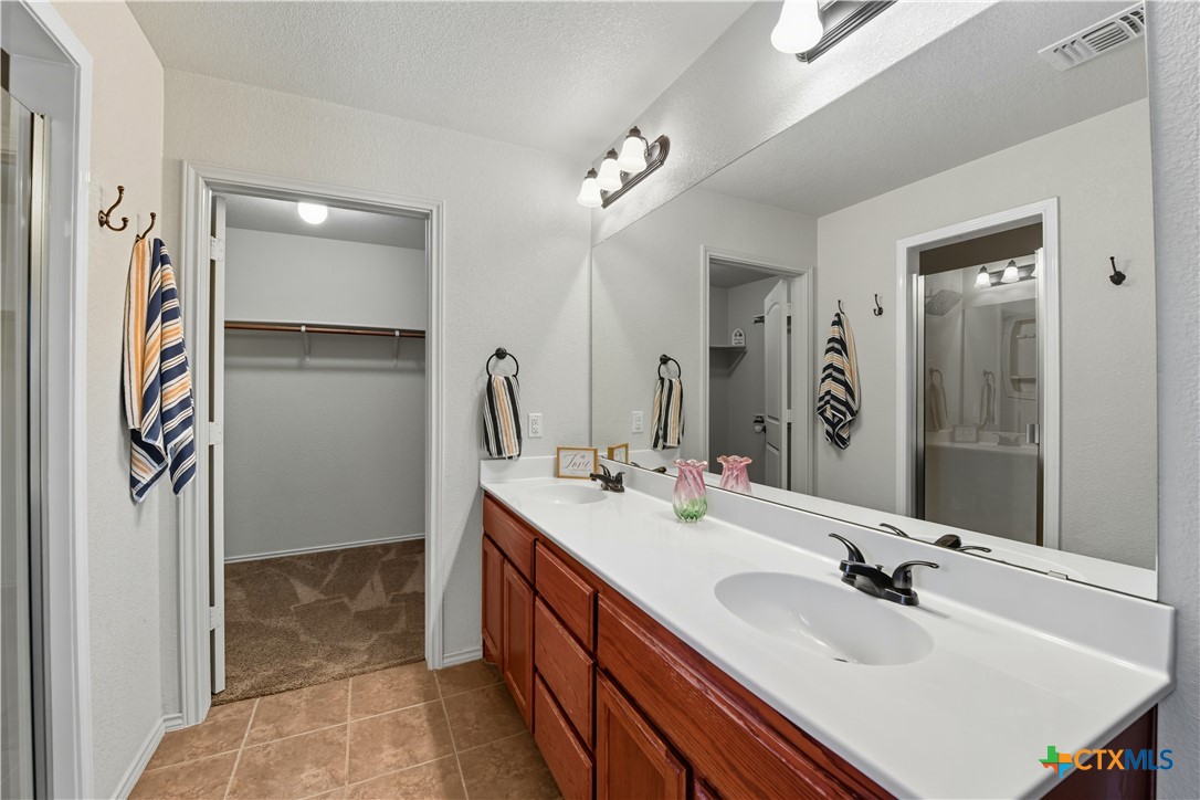2411 Settlement Road Copperas Cove, TX 76522 - Photo 16 of 38 a bathroom with a sink double vanity and a mirror