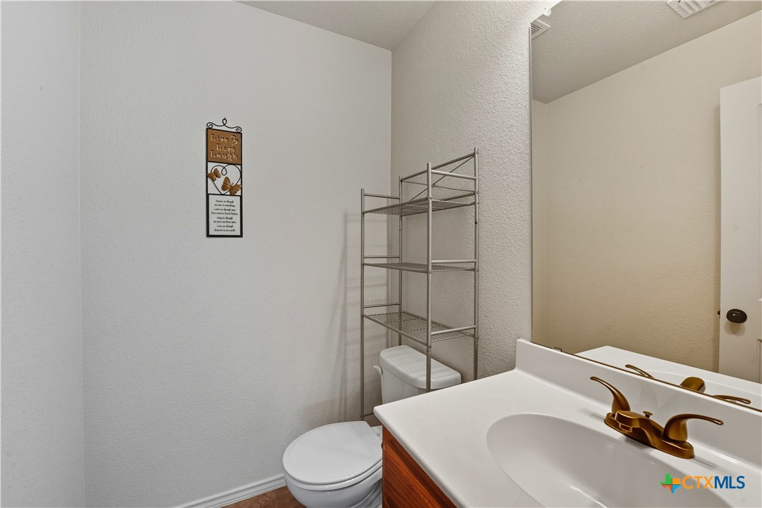 2411 Settlement Road Copperas Cove, TX 76522 - Photo 28 of 38 a bathroom with a sink toilet and vanity
