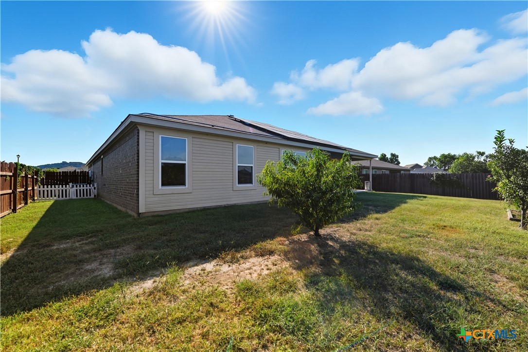 2411 Settlement Road Copperas Cove, TX 76522 - Photo 35 of 38 a view of a backyard with grass and a large tree