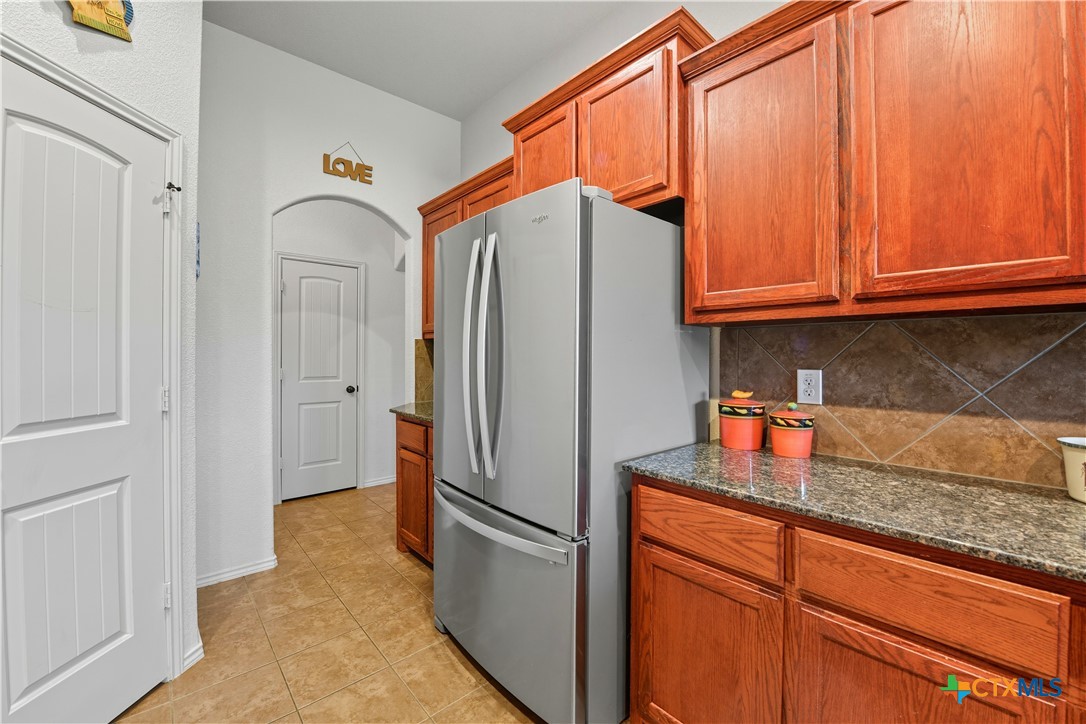 2411 Settlement Road Copperas Cove, TX 76522 - Photo 9 of 38 a kitchen with stainless steel appliances granite countertop a refrigerator and a sink
