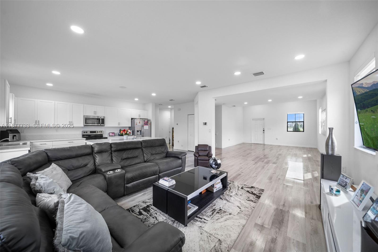 12833 Southwest 229th Terrace Miami, FL 33170 - Photo 11 of 43 a living room with furniture and a wooden floor