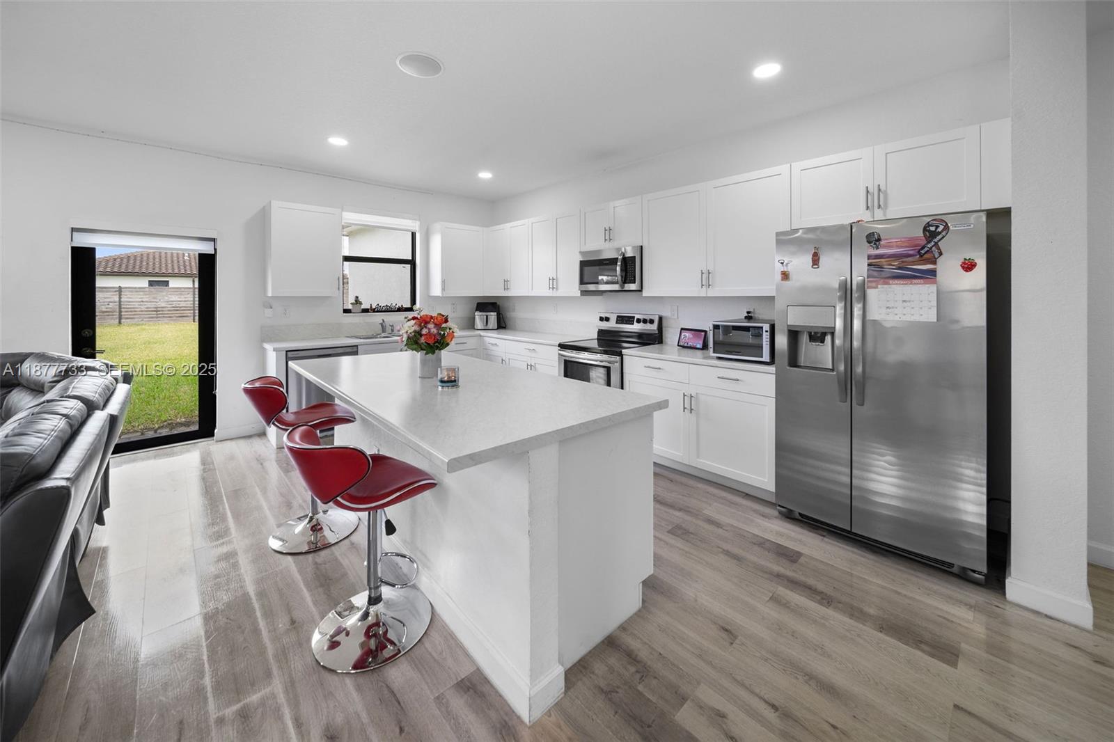 12833 Southwest 229th Terrace Miami, FL 33170 - Photo 12 of 43 a large kitchen with a table and chairs