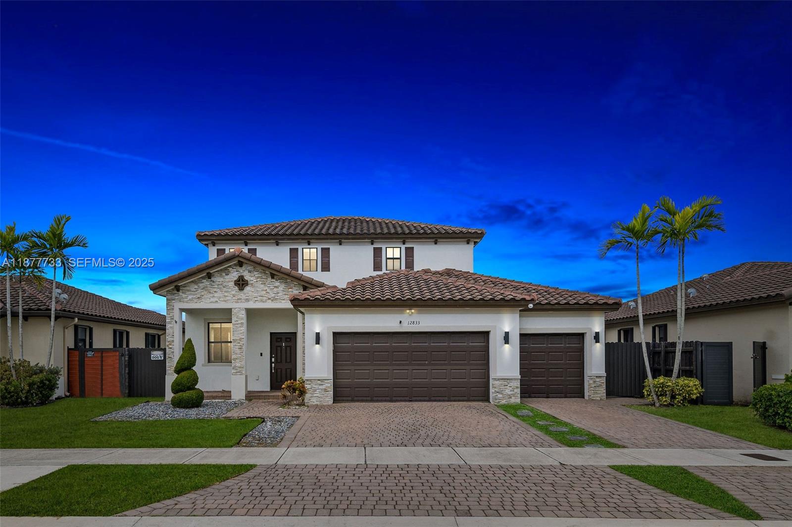 12833 Southwest 229th Terrace Miami, FL 33170 - Photo 2 of 43 a front view of a house with a yard and garage