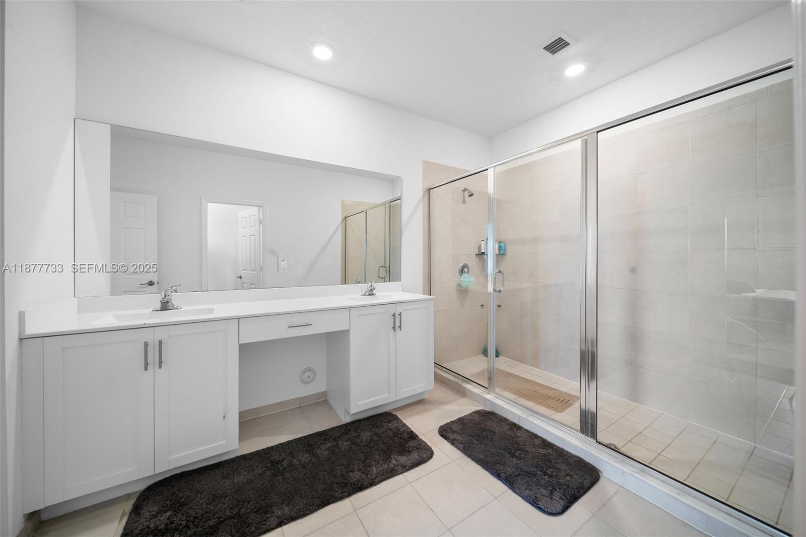 12833 Southwest 229th Terrace Miami, FL 33170 - Photo 26 of 43 a spacious bathroom with a shower sink and mirror
