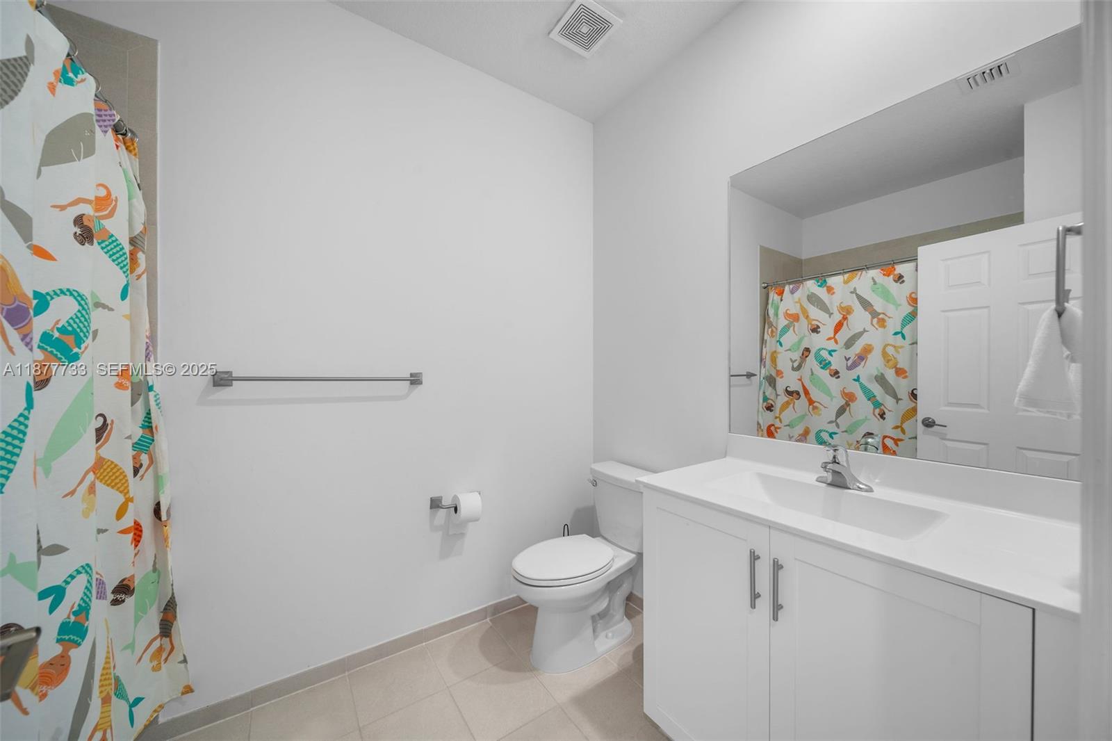 12833 Southwest 229th Terrace Miami, FL 33170 - Photo 30 of 43 a bathroom with a sink a toilet and shower curtain