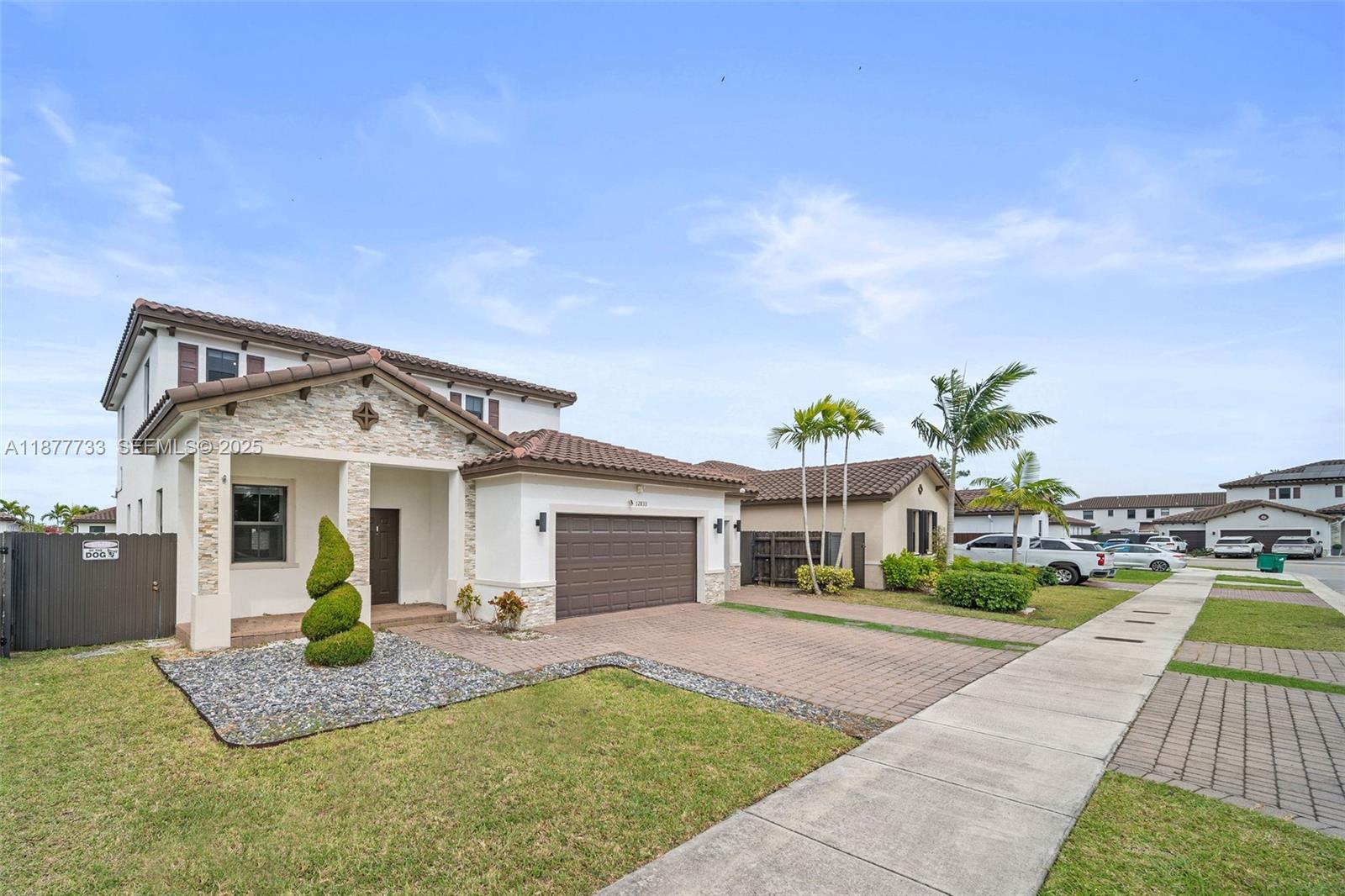 12833 Southwest 229th Terrace Miami, FL 33170 - Photo 3 of 43 a view of a white house with a patio and a yard