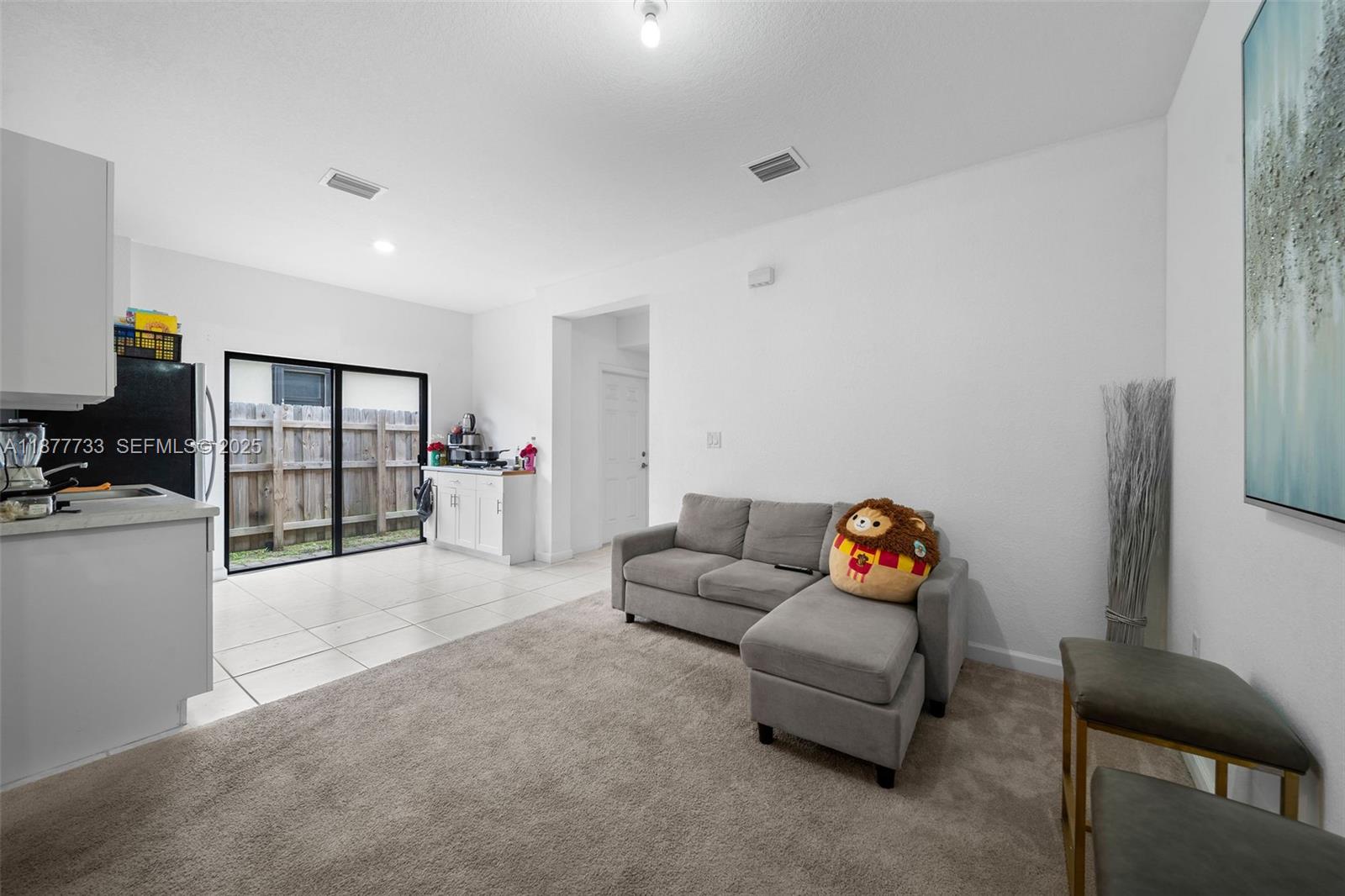 12833 Southwest 229th Terrace Miami, FL 33170 - Photo 36 of 43 a living room with furniture and a flat screen tv