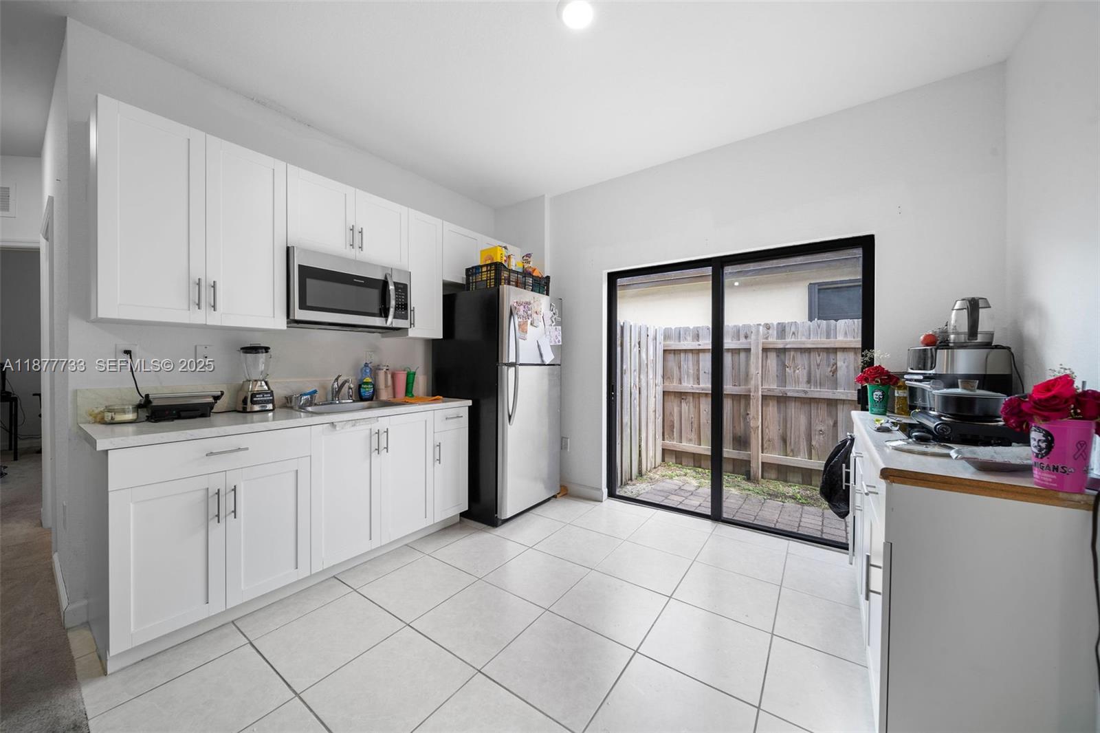 12833 Southwest 229th Terrace Miami, FL 33170 - Photo 37 of 43 a kitchen with stainless steel appliances granite countertop a refrigerator sink and cabinets