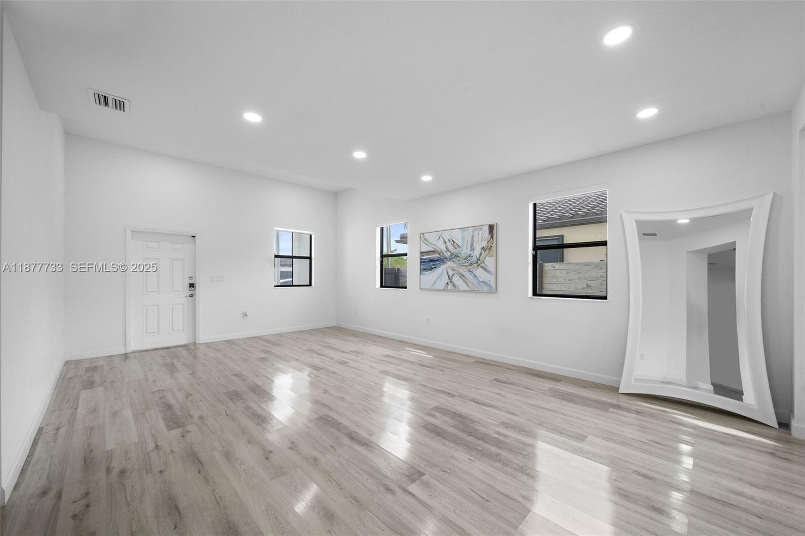 12833 Southwest 229th Terrace Miami, FL 33170 - Photo 6 of 43 a view of empty room with wooden floor and window