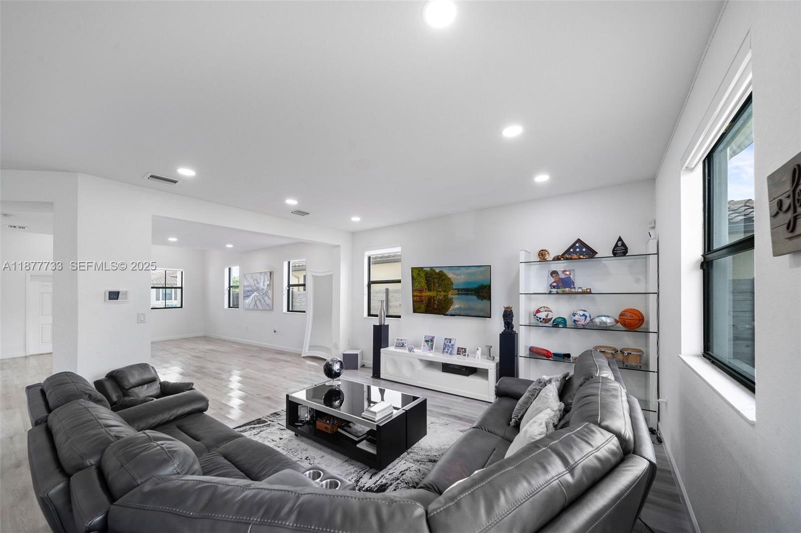 12833 Southwest 229th Terrace Miami, FL 33170 - Photo 9 of 43 a living room with furniture and a flat screen tv