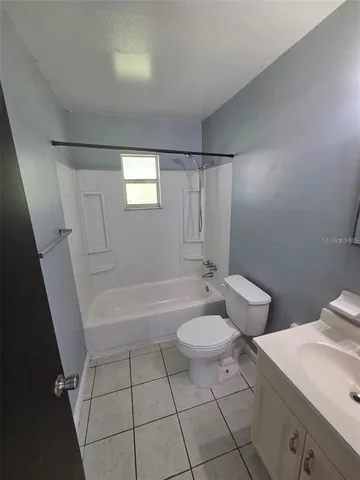 a bathroom with a sink a toilet and bathtub