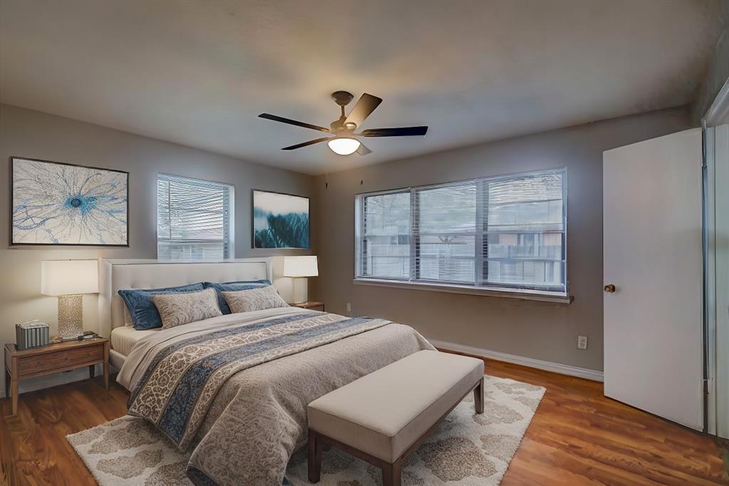 1004 Pecan Avenue Wills Point, TX 75169 - Photo 11 of 21 a bedroom with a large bed chandelier and a window