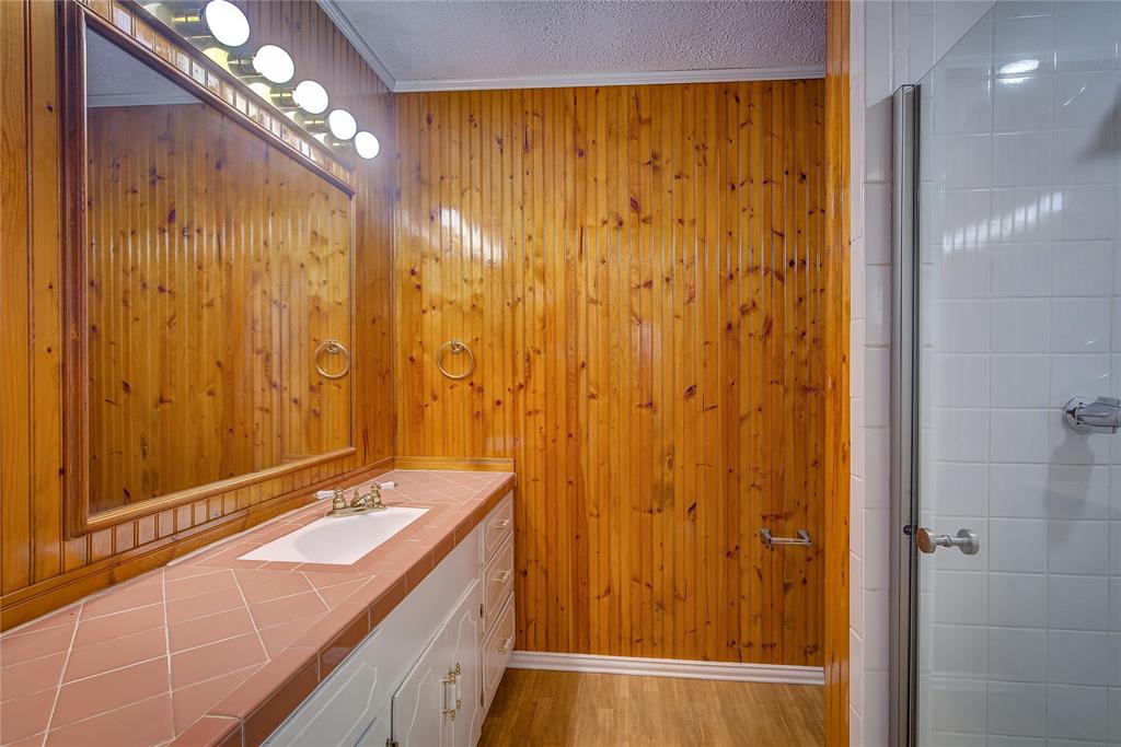 1004 Pecan Avenue Wills Point, TX 75169 - Photo 12 of 21 a bathroom with a double vanity sink and a mirror