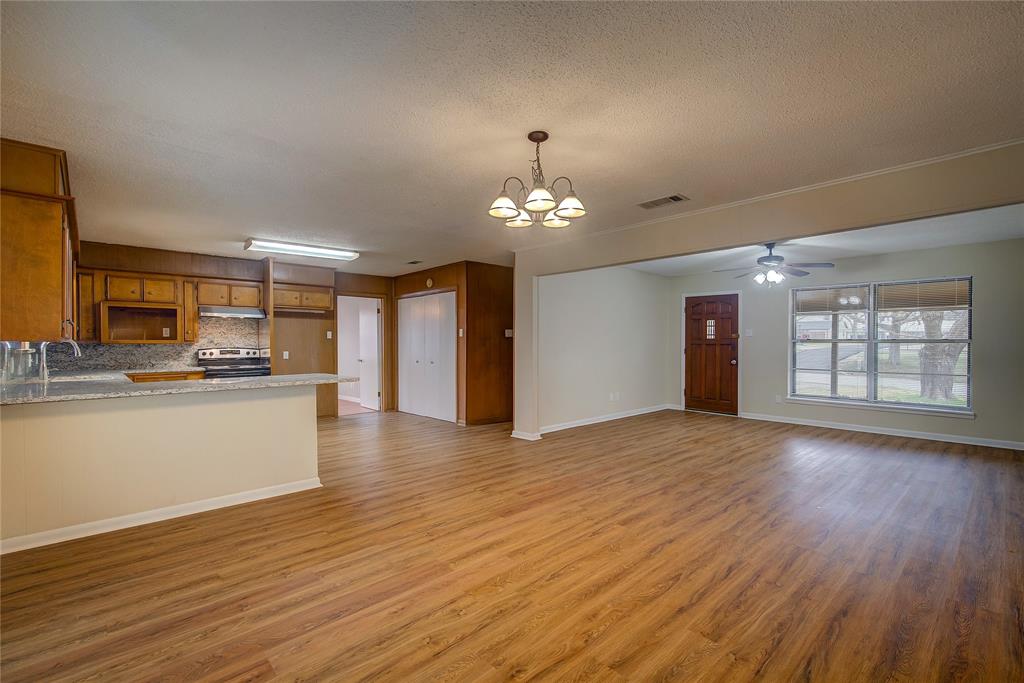 1004 Pecan Avenue Wills Point, TX 75169 - Photo 6 of 21 a view of an empty room with window and wooden floor