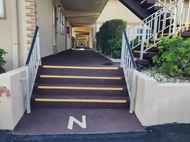 a kitchen with white cabinets and a refrigerator