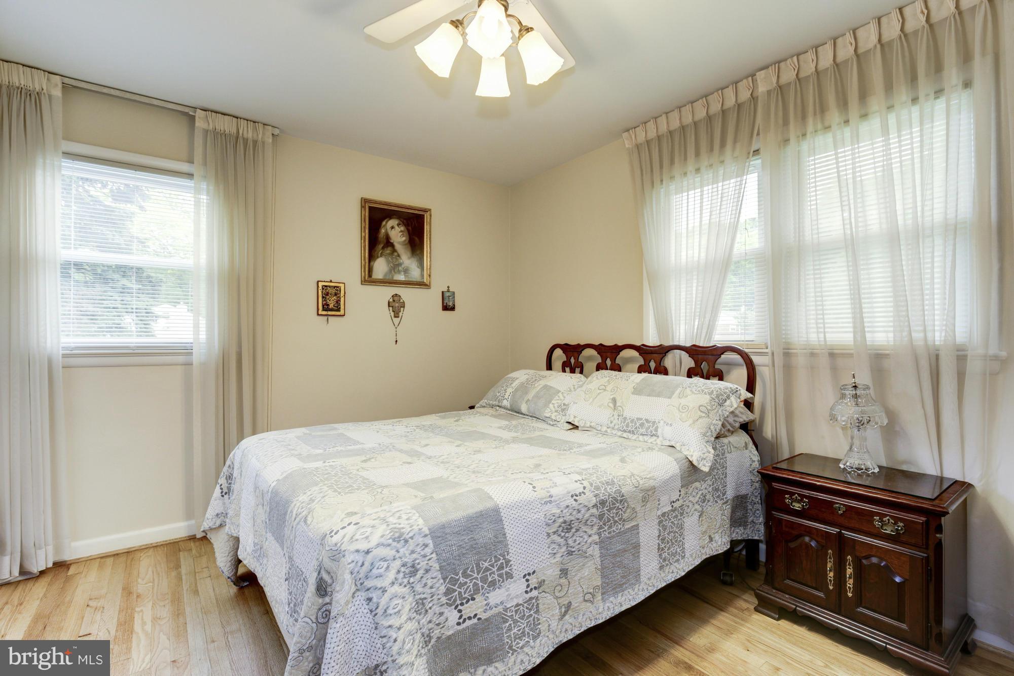 1305 Oakview Drive Silver Spring, MD 20903 - Photo 11 of 26 a bedroom with a bed and wooden floor