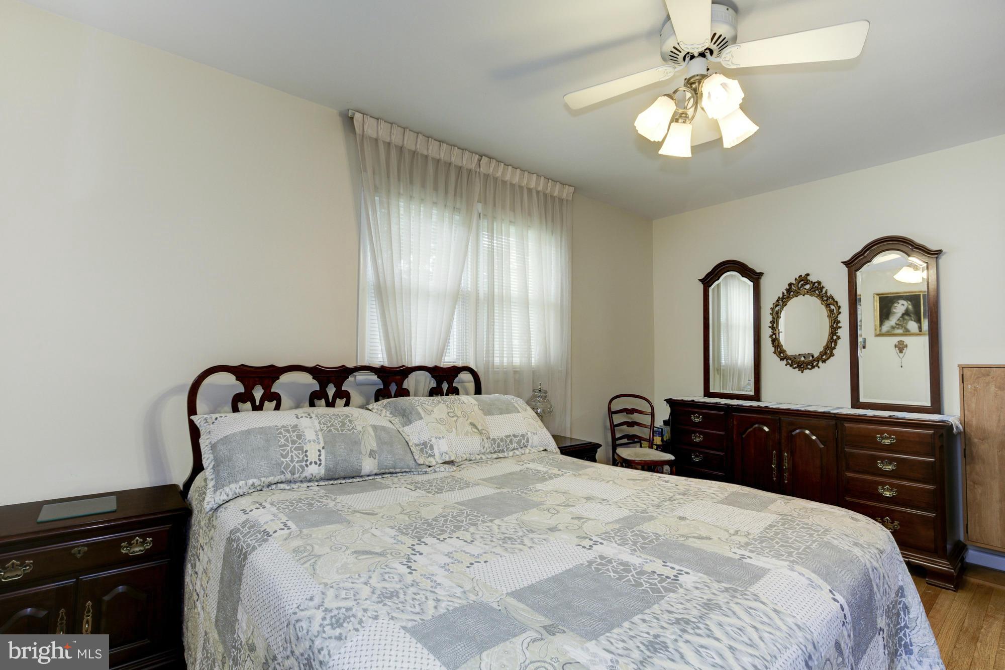 1305 Oakview Drive Silver Spring, MD 20903 - Photo 12 of 26 a bedroom with a bed and a chandelier