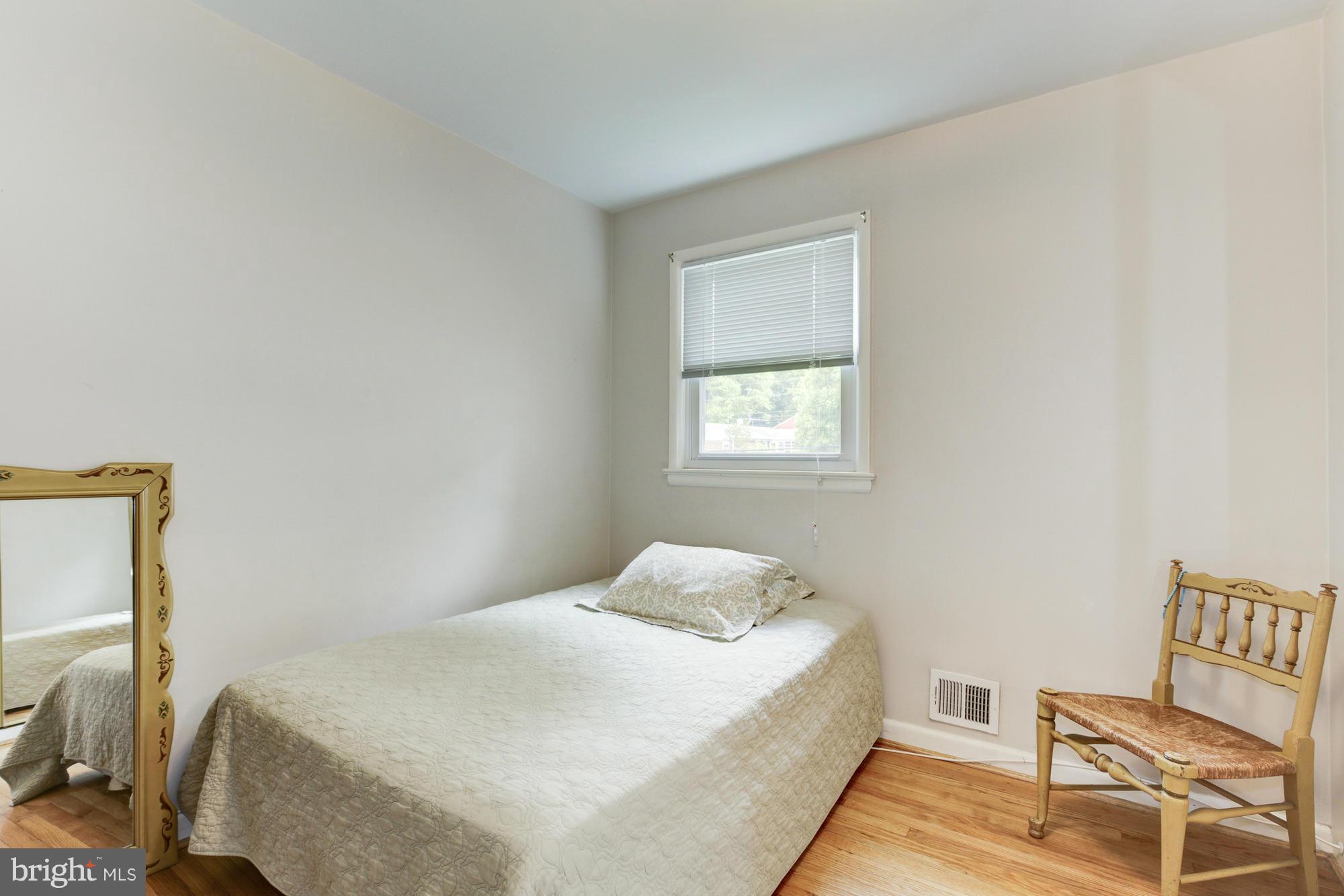 1305 Oakview Drive Silver Spring, MD 20903 - Photo 14 of 26 a bedroom with a bed and a window