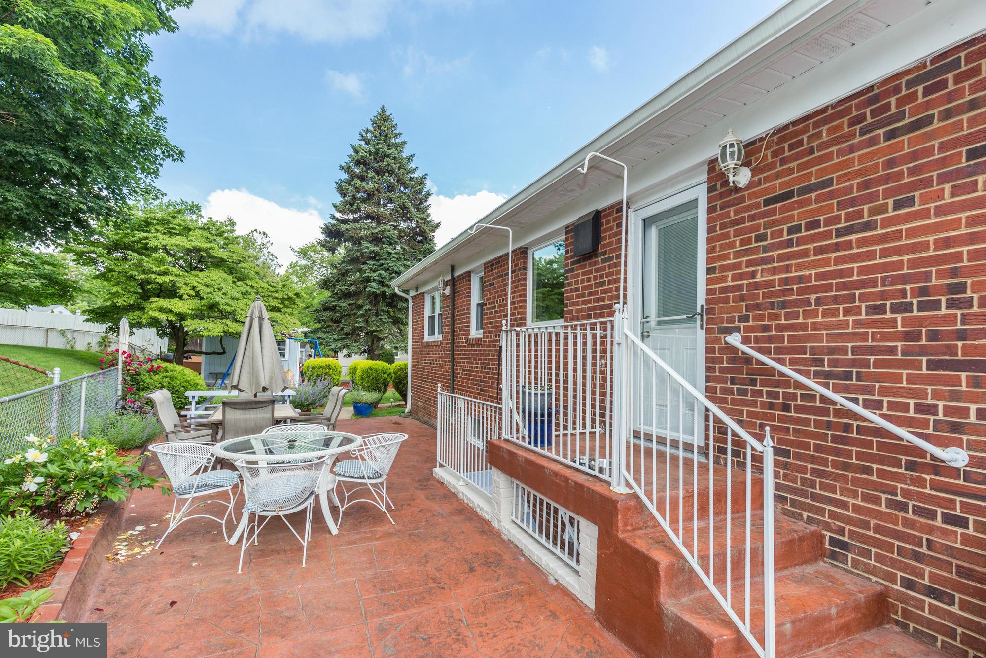 1305 Oakview Drive Silver Spring, MD 20903 - Photo 24 of 26 a view of a patio with a table and chairs and potted plants