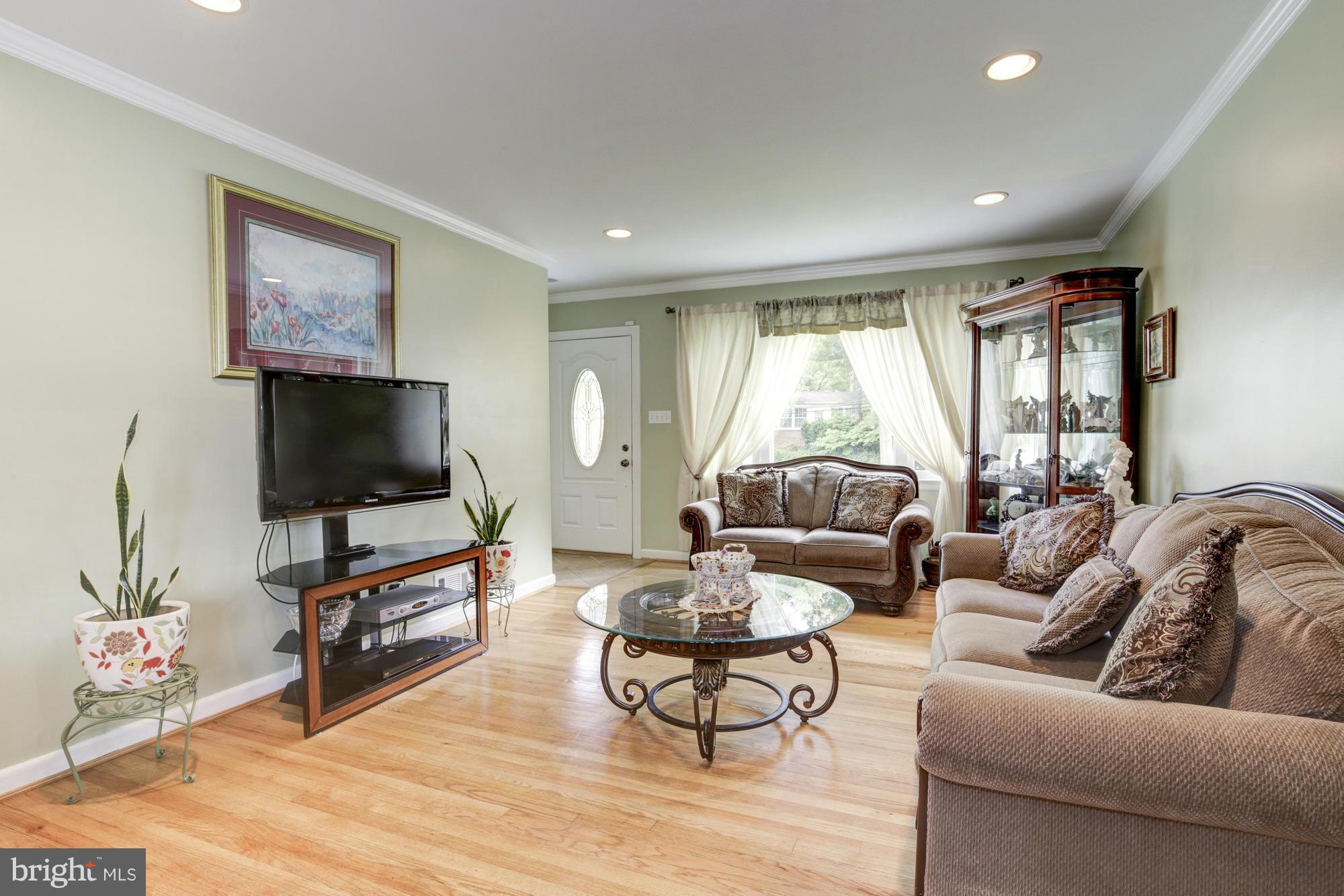 1305 Oakview Drive Silver Spring, MD 20903 - Photo 4 of 26 a living room with furniture and a flat screen tv