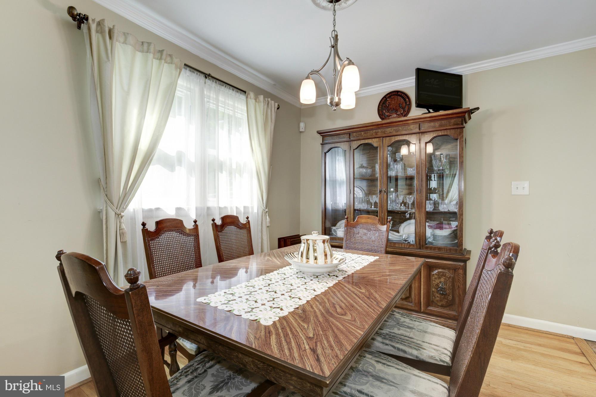 1305 Oakview Drive Silver Spring, MD 20903 - Photo 5 of 26 a view of a dining room with furniture window and wooden floor