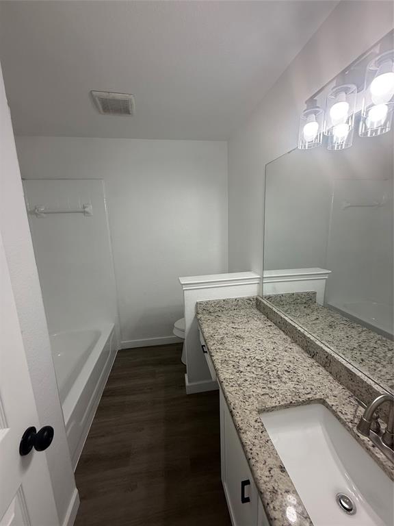 6005 Meadowdale Road Arlington, TX 76017 - Photo 11 of 20 a bathroom with a granite countertop sink and a mirror