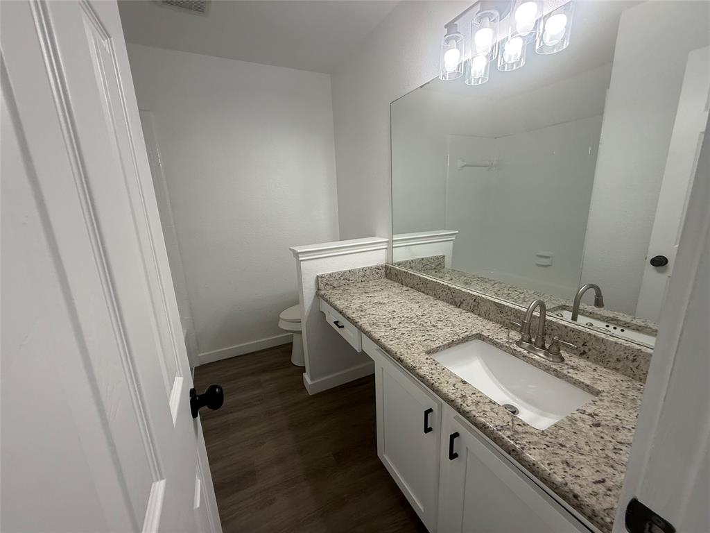 6005 Meadowdale Road Arlington, TX 76017 - Photo 13 of 20 a bathroom with a granite countertop sink and a mirror